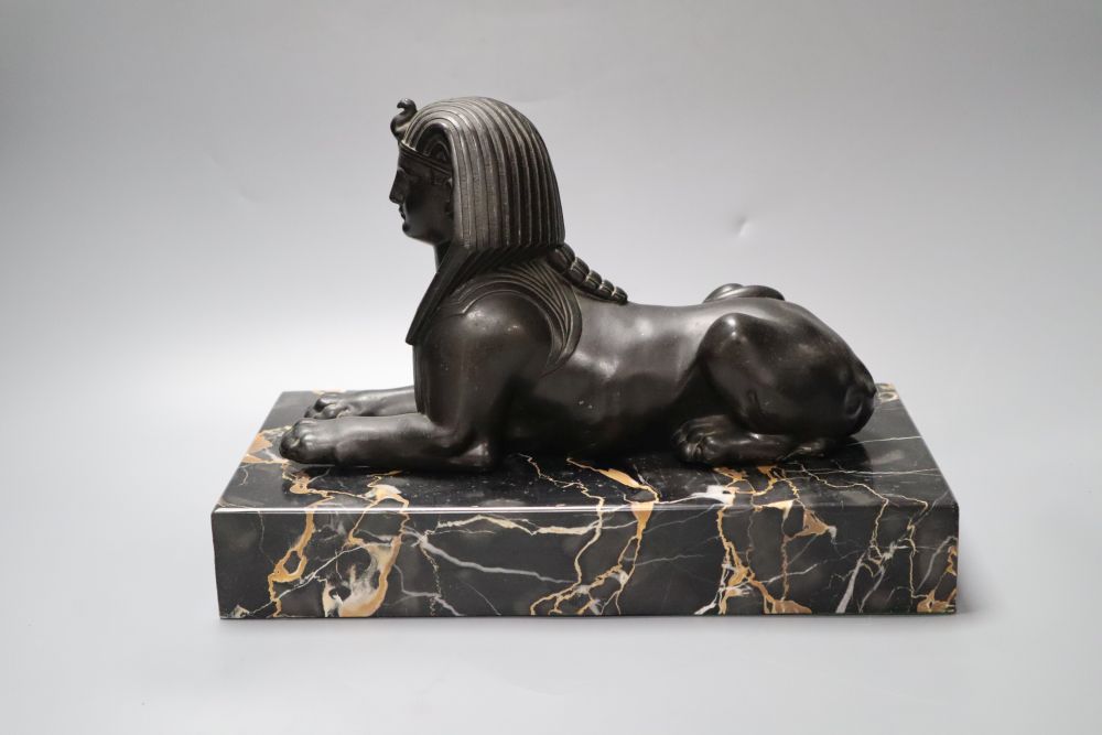 A bronzed spelter and marble sphinx, on marble plinth, height 32cm